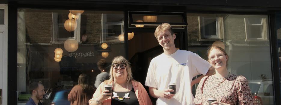 Sam from Rise Up Clean Up with Will and Charlotte from Oast outside the bakery with The Margate Cup.